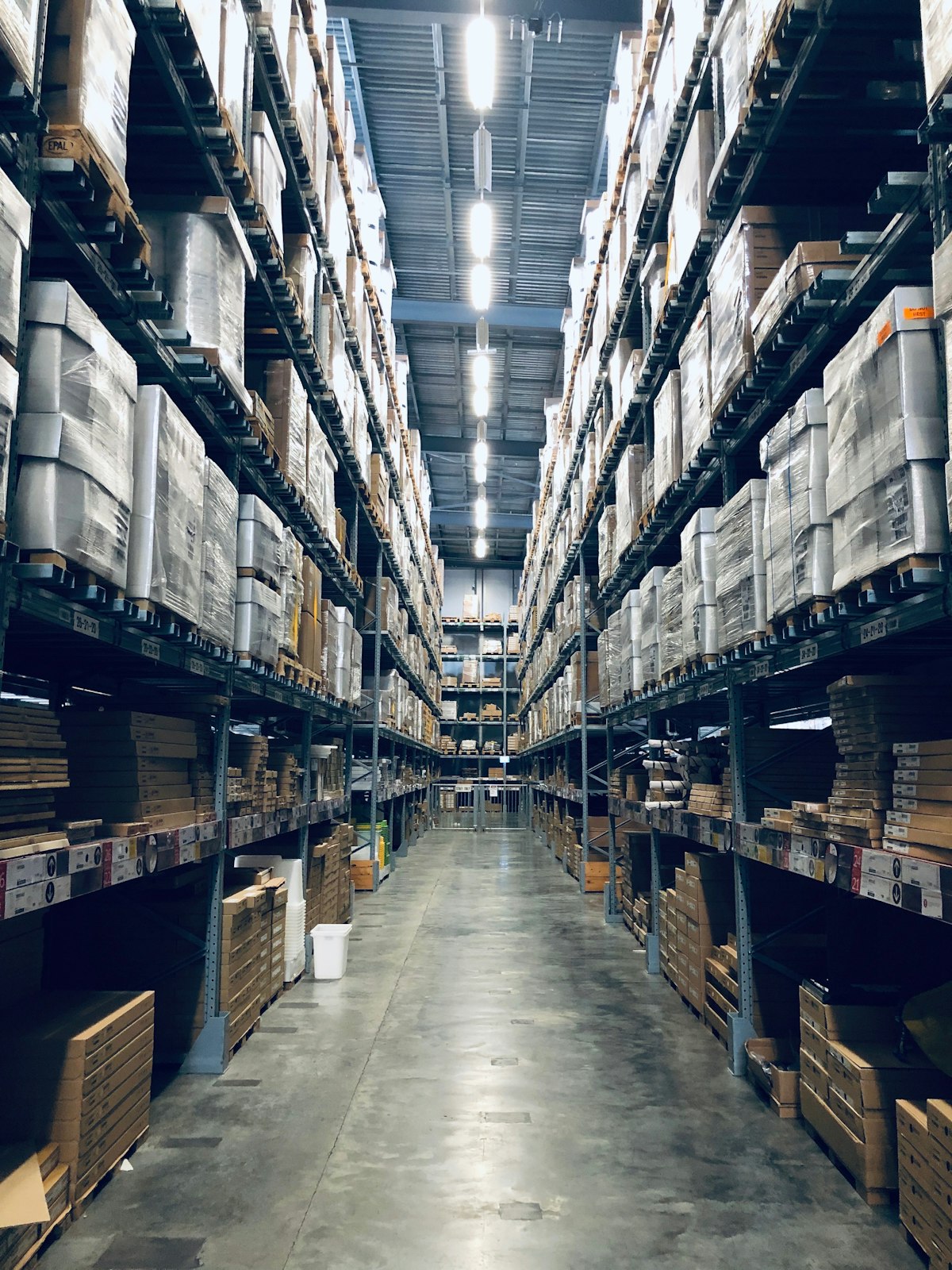 Warehouse aisle with stocked pallet racking